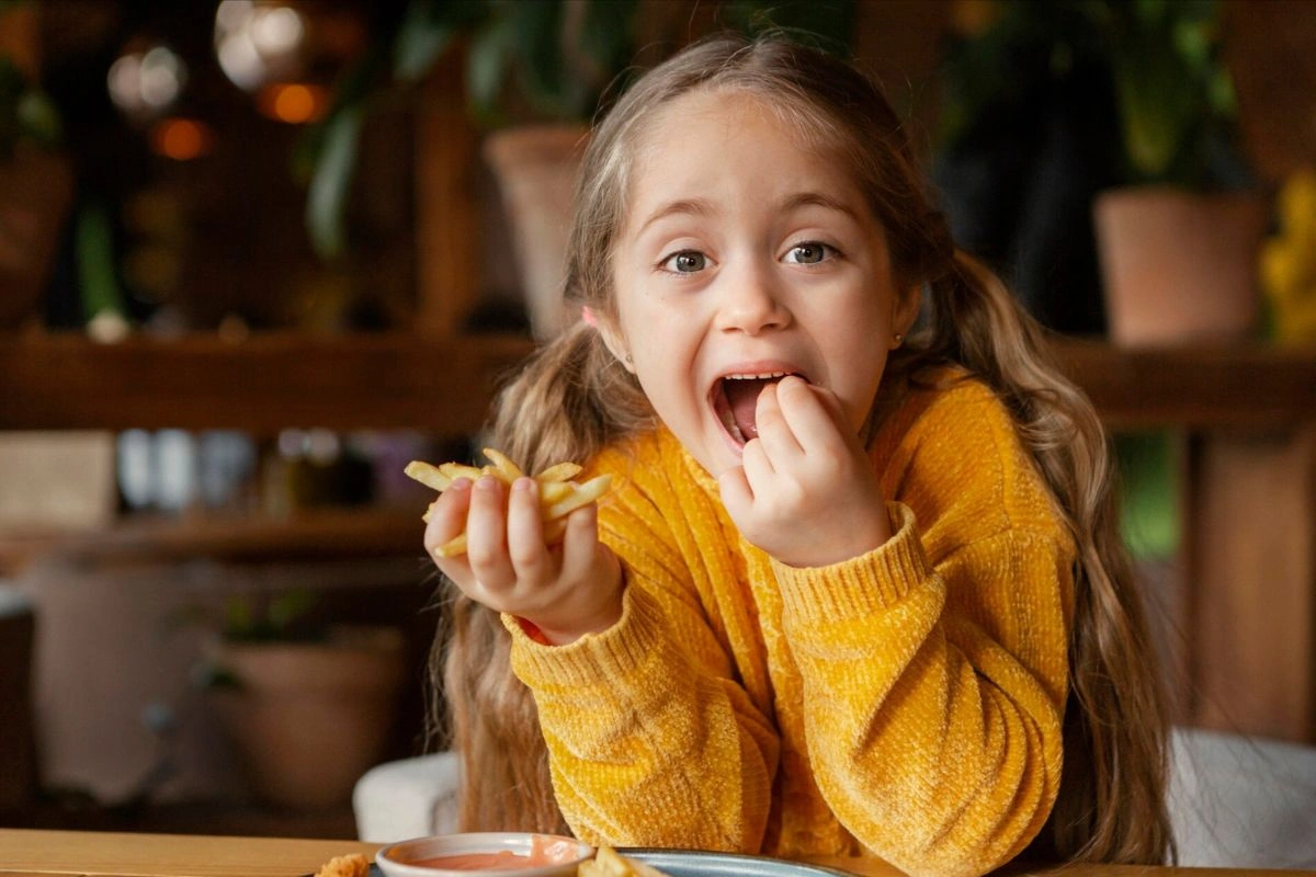 Little girl enjoying kid's menu in  Prixos 32 at Palmar Beach Resort