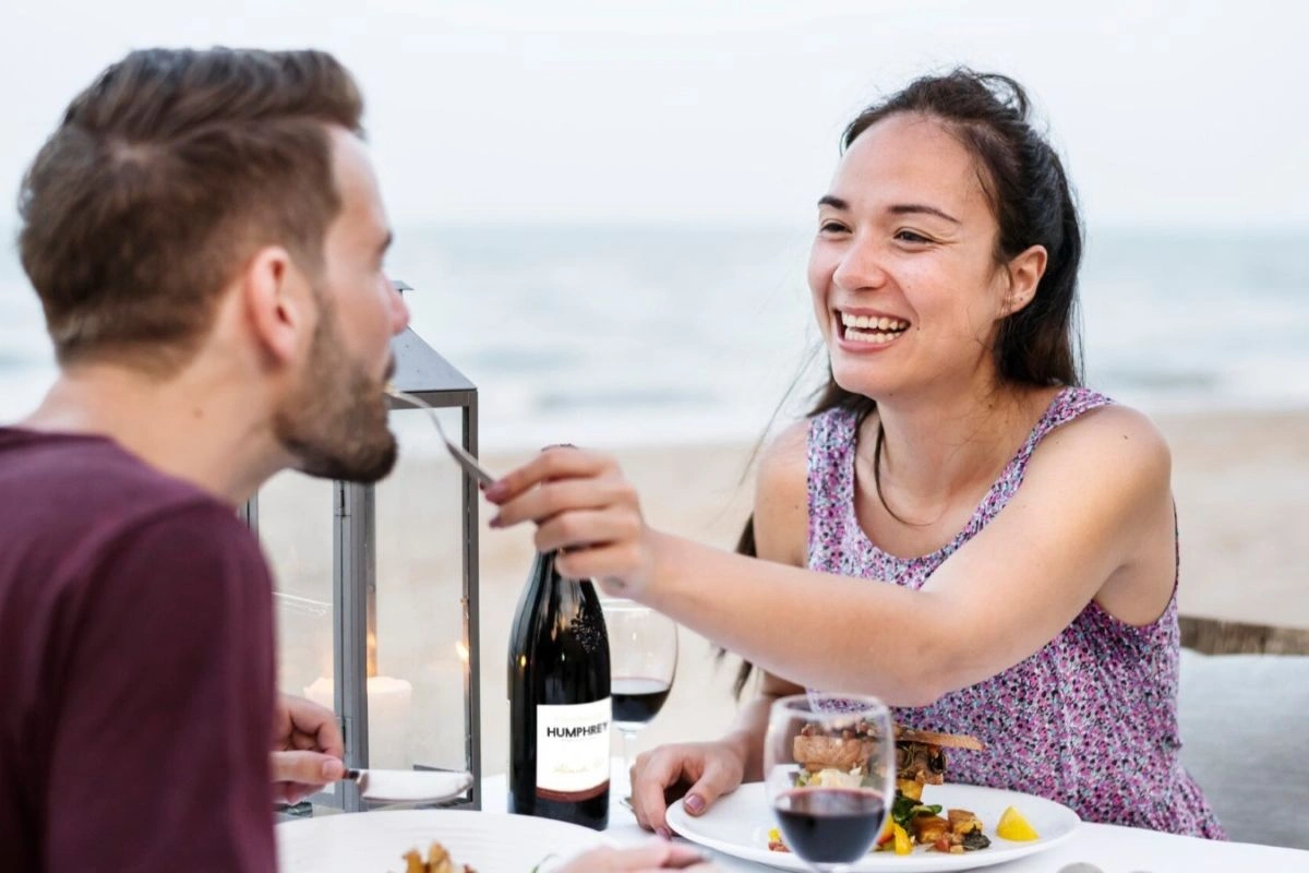 Couple enjoying a romantic dinner in front of the beach