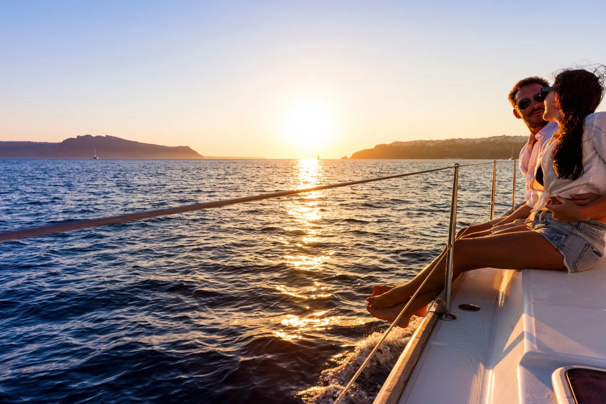 Couple having a romantic day looking a beautiful sunset on a cruise ship