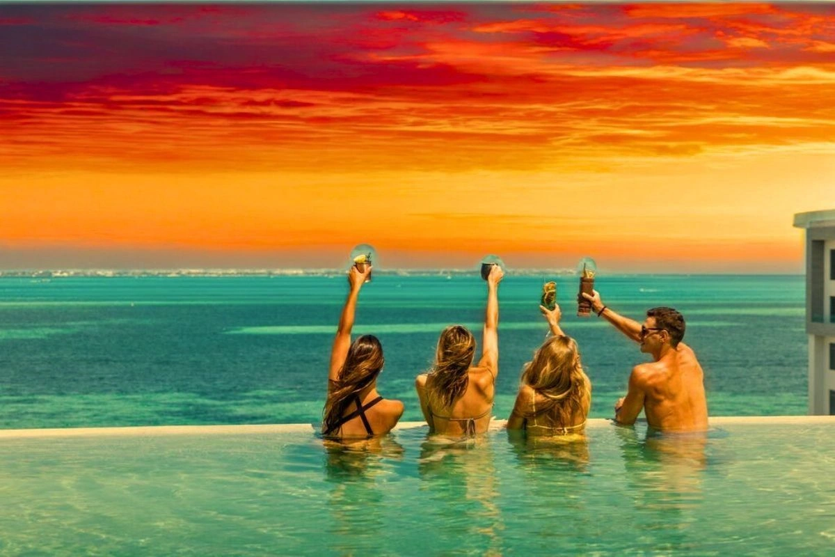 Celebrating in the pool looking a sunset