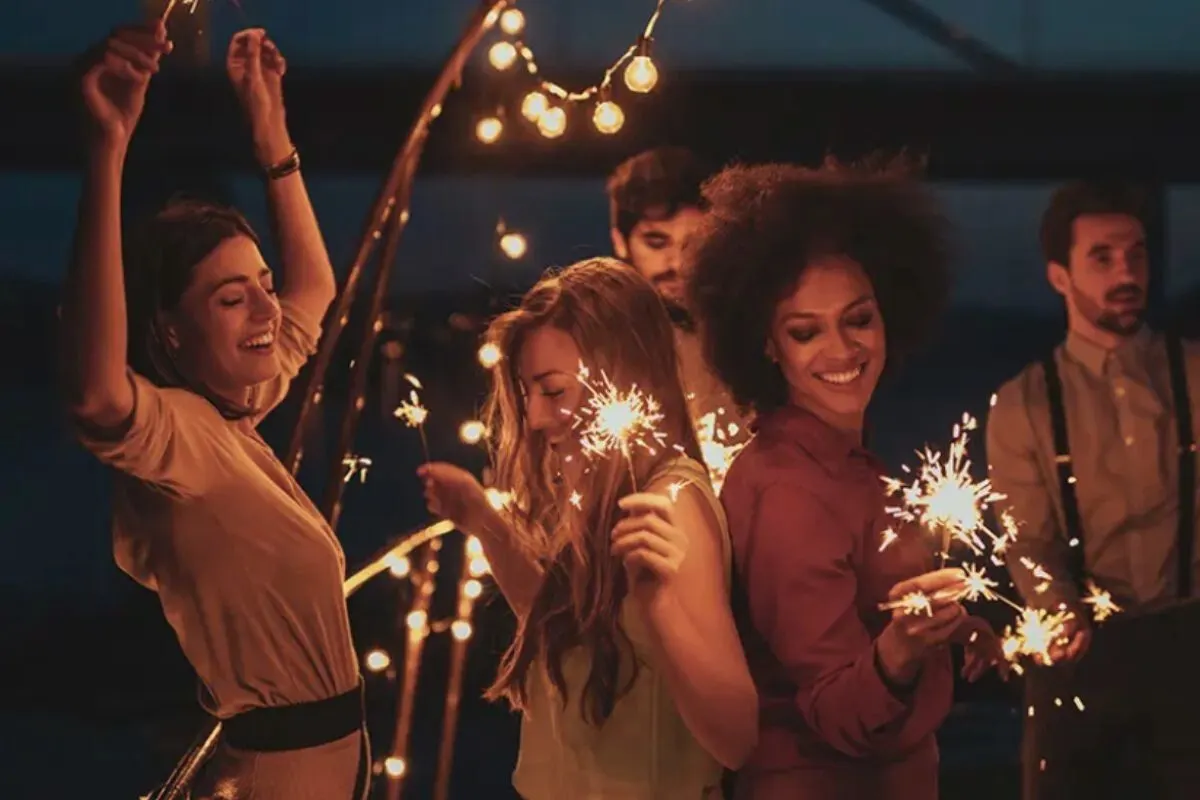 People enjoying the night dancing with sparks