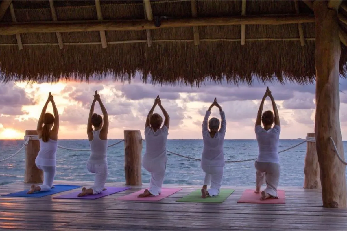 Doing yoga in front of the beach with a spectacular view